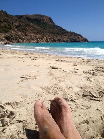 St. Barths beach and foot in the sand photo by Iron MusicVEVO